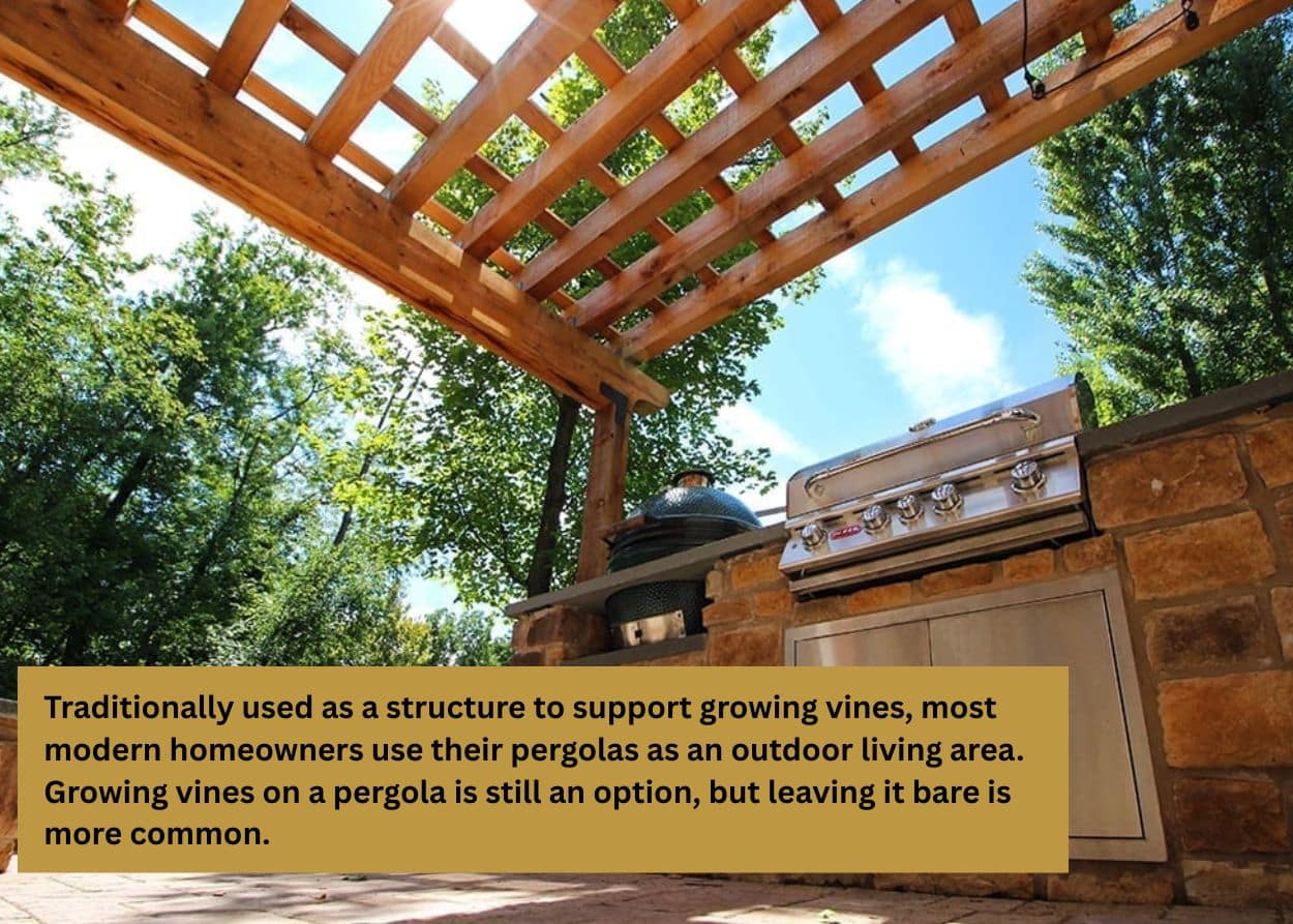 Outdoor kitchen with a wooden pergola overhead, featuring a built-in grill and stone counters surrounded by trees. Caption: The warm tones and organic texture of cedar or redwood fit right in among trees and stone patios, creating a timeless, rustic charm. However, the region’s fluctuating humidity and freeze-thaw cycles can take a toll. Wood requires regular sealing or staining to prevent rot, warping, and fading over time.